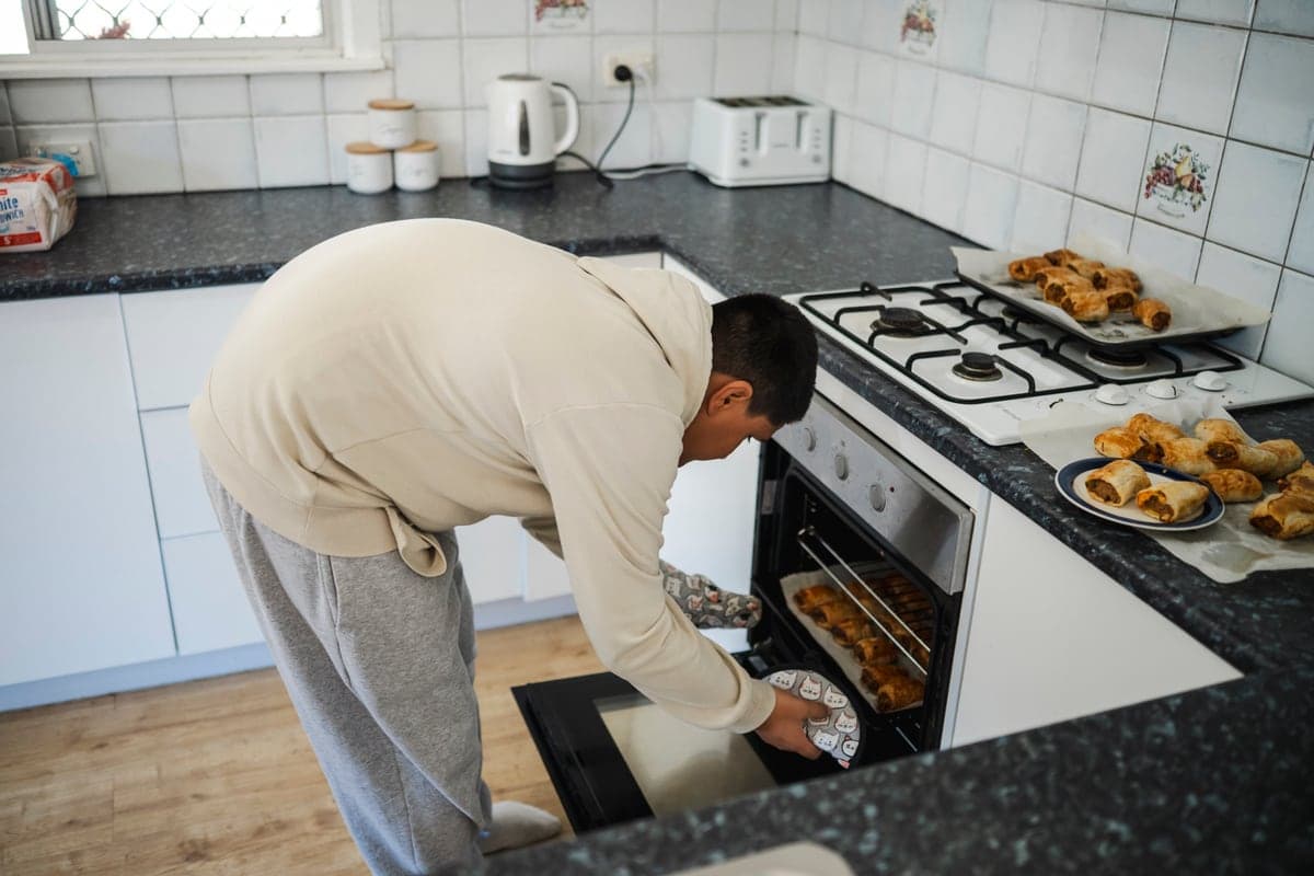 Taking a tray out of the oven during a cooking session